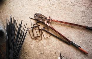 Steel wire cutter and reinforcement steel on the concrete floor photo