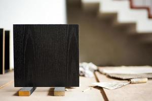 Closeup black wooden board in square shape on the stand photo