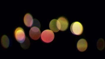 Realistic colorful light bokeh blur on black background.
