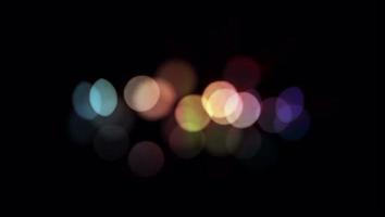 Realistic colorful light bokeh blur on black background. video