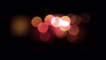 Realistic colorful light bokeh blur on black background.