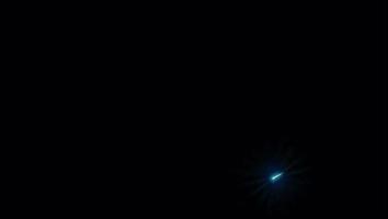 Realistic light blue meteor shower with black background.