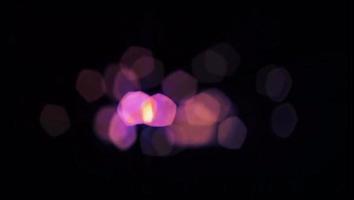 Realistic purple light bokeh blur on black background. video