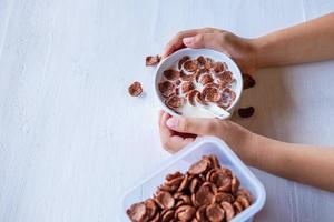 Bowl of cereal in hands photo