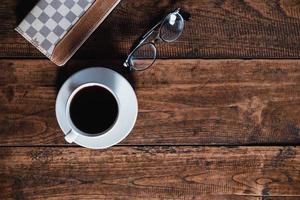 Top view of coffee, glasses, and a book photo