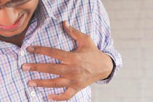 Man holding chest in pain photo