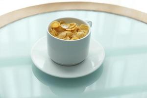 Corn flakes in a bowl on table photo