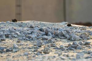 Texture and background of crashed stone pile at the construction site with light of sunset photo