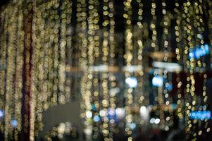 Abstract background and texture of golden bokeh lights for decoration in the outdoor event photo