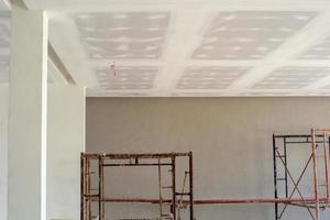 Plastered white cement applied on the ceiling board of a house under construction. photo