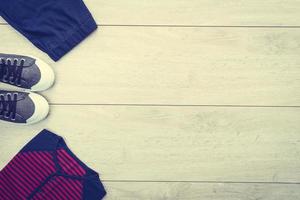 T-shirt with pants and shoes on wooden background photo