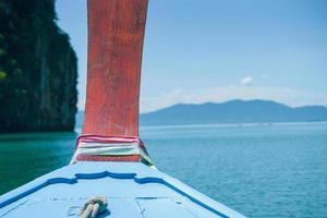 Closeup wooden plate of the boat head tied by colorful clothes for luckiness photo