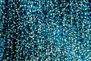 Abstract picture of blurred glittering turquoise bokeh in background photo