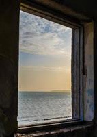 View of the sea from a window photo