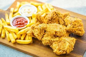 Fried chicken wings with french fries and tomato or ketchup and mayonnaise sauce