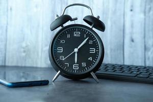 Black alarm clock on desk photo