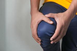 Man holding knee in pain photo