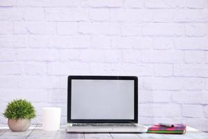 Laptop with blank screen on office desk photo