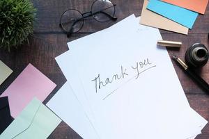 Thank you note on white paper photo