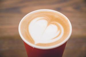 Heart latte coffee in red cup photo