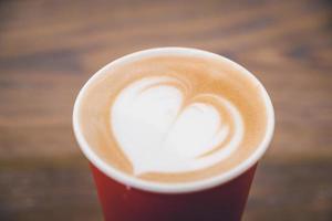 Heart latte coffee in red cup photo