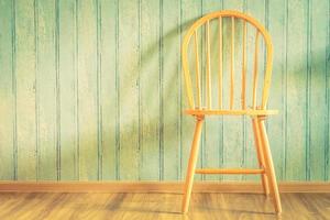 Vintage wood chair on wood background photo