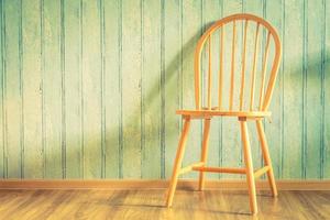 Vintage wood chair on wood background photo