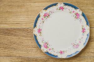 Vintage plate on wooden background photo