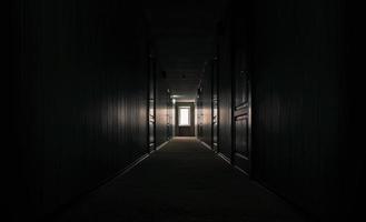 Dark hallway with sunlight coming in photo