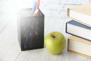 School concept with apple on notepad on table photo