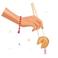 A hand with Chinese chopsticks holds a fortune cookie vector