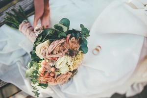 Floral bouquet and wedding bands photo