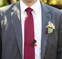 Groom in a jacket with boutonniere photo