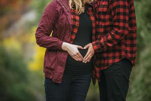 Pregnant couple in red photo