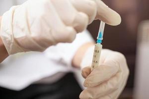 El doctor sostiene una jeringa con una vacuna. foto