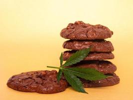 Medicinal edibles cookies with marijuana on yellow background photo