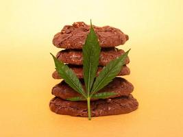 Medicinal edibles cookies with marijuana on yellow background photo