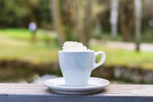 Delicious coffee isolated on brown background photo