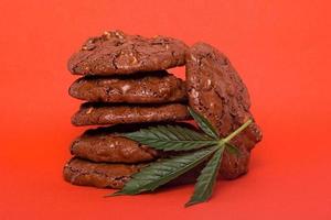 Cannabis cookies on red background photo