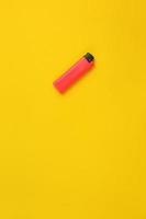 Single lighter on vivid yellow background. Creative concept photo of minimalism.