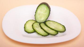 Sliced fresh cucumbers on a white plate photo