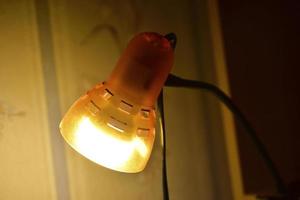 Yellow lamp in a dark room close-up photo