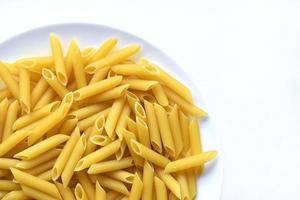 Yellow delicious pasta close-up on a white plate photo