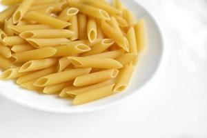 Yellow delicious pasta close-up on a white plate photo