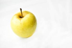 Yellow clean and fresh apple on a white background photo