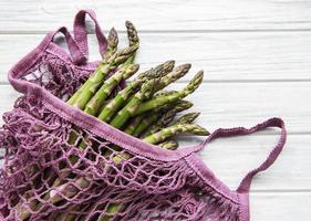 Asparagus stems in an eco mesh bag photo