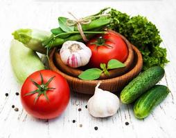 Various vegetables on an old wooden background photo