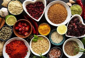 Various spices in a bowls on black concrete background. Top view copy space. photo