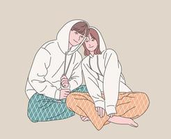 Couples in pajamas are sitting affectionately. hand drawn style vector design illustrations.