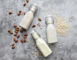 Bottles with different vegetable milk photo